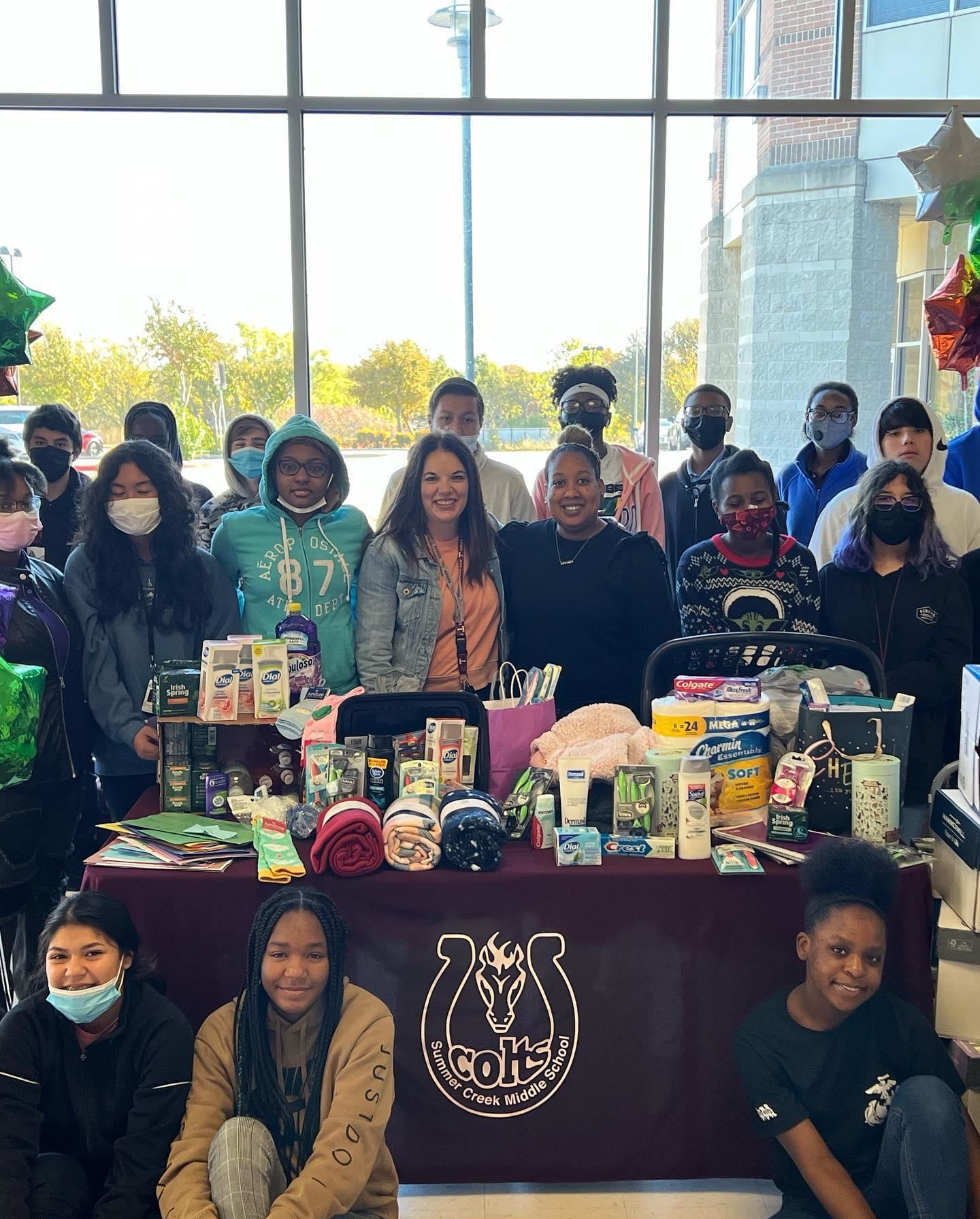 Summer Creek Middle School Students with donated items inside school