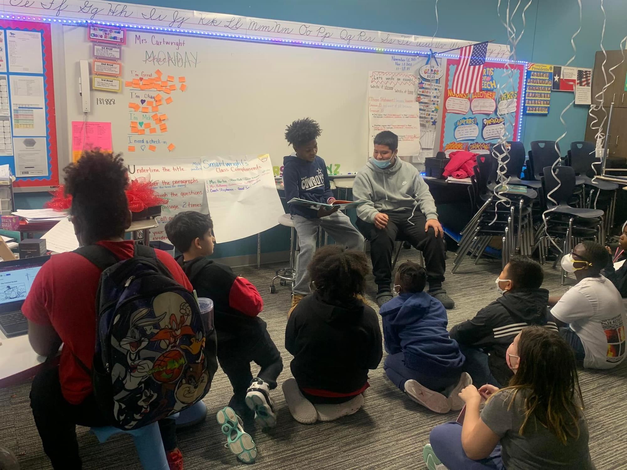 North Crowley 9th Grade students reading to a group of students at June W. Davis Elementary
